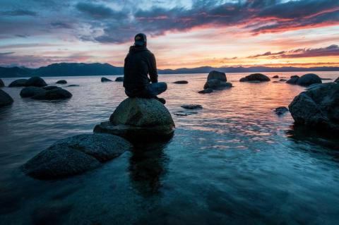 man sitting on a rock