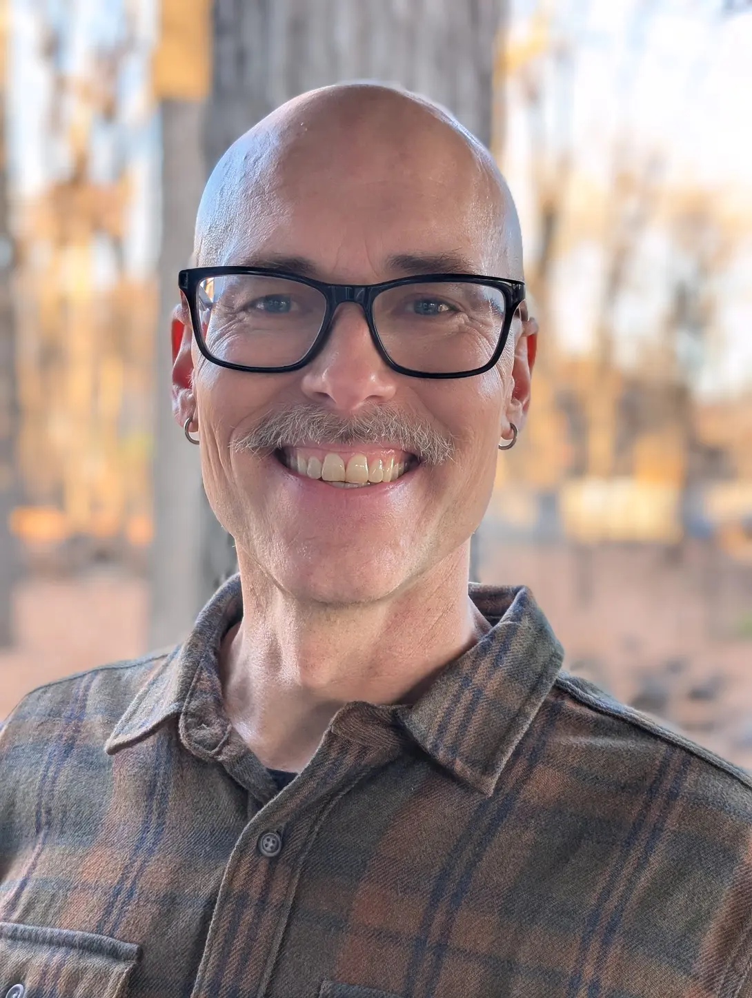 Matthew with a grey mustache outside in Movember 2025